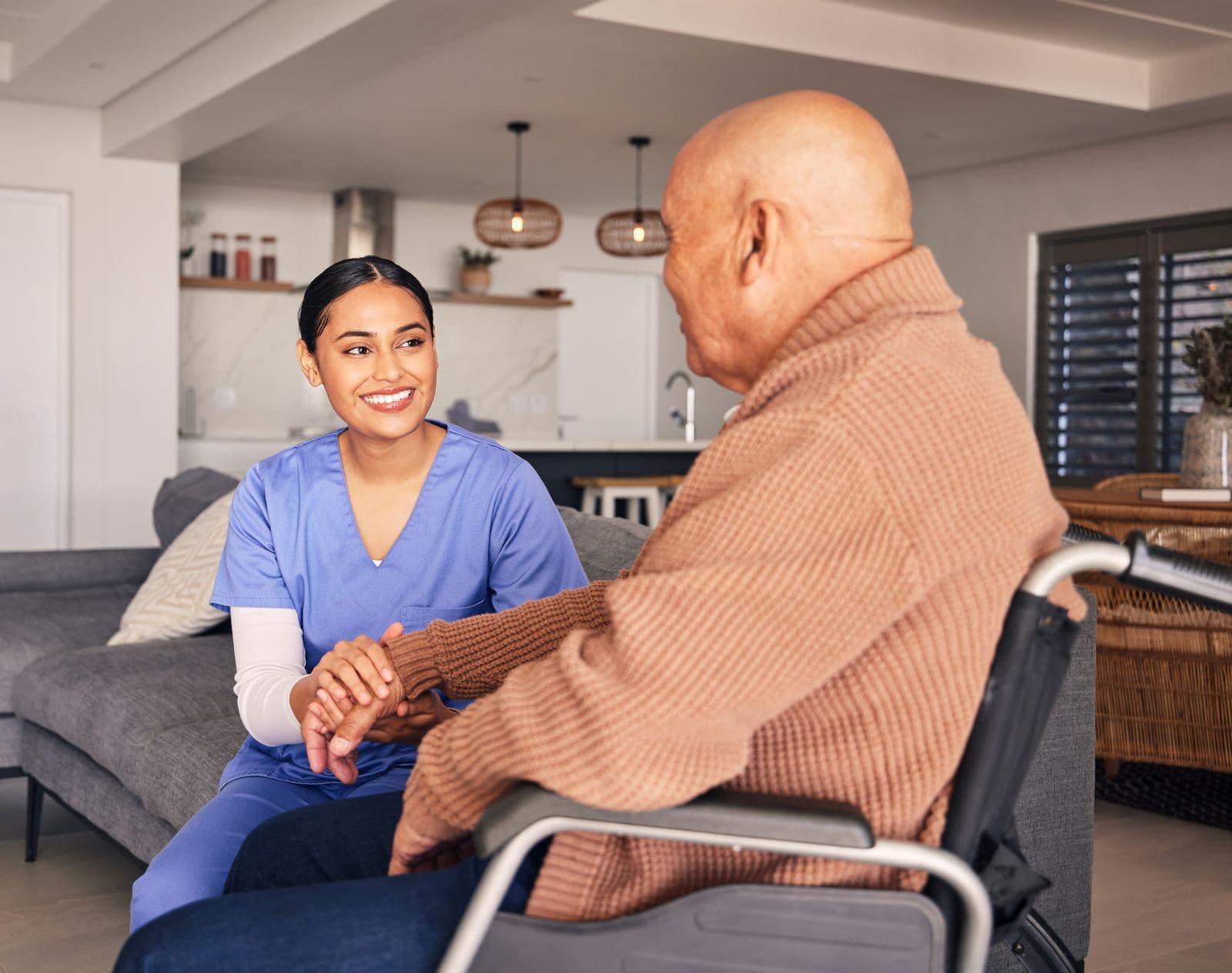 CHPPN Exam Preparation and Resources Nurse supporting a disabled man in a wheelchair, representing CHPPN hospice and palliative care certification professionals