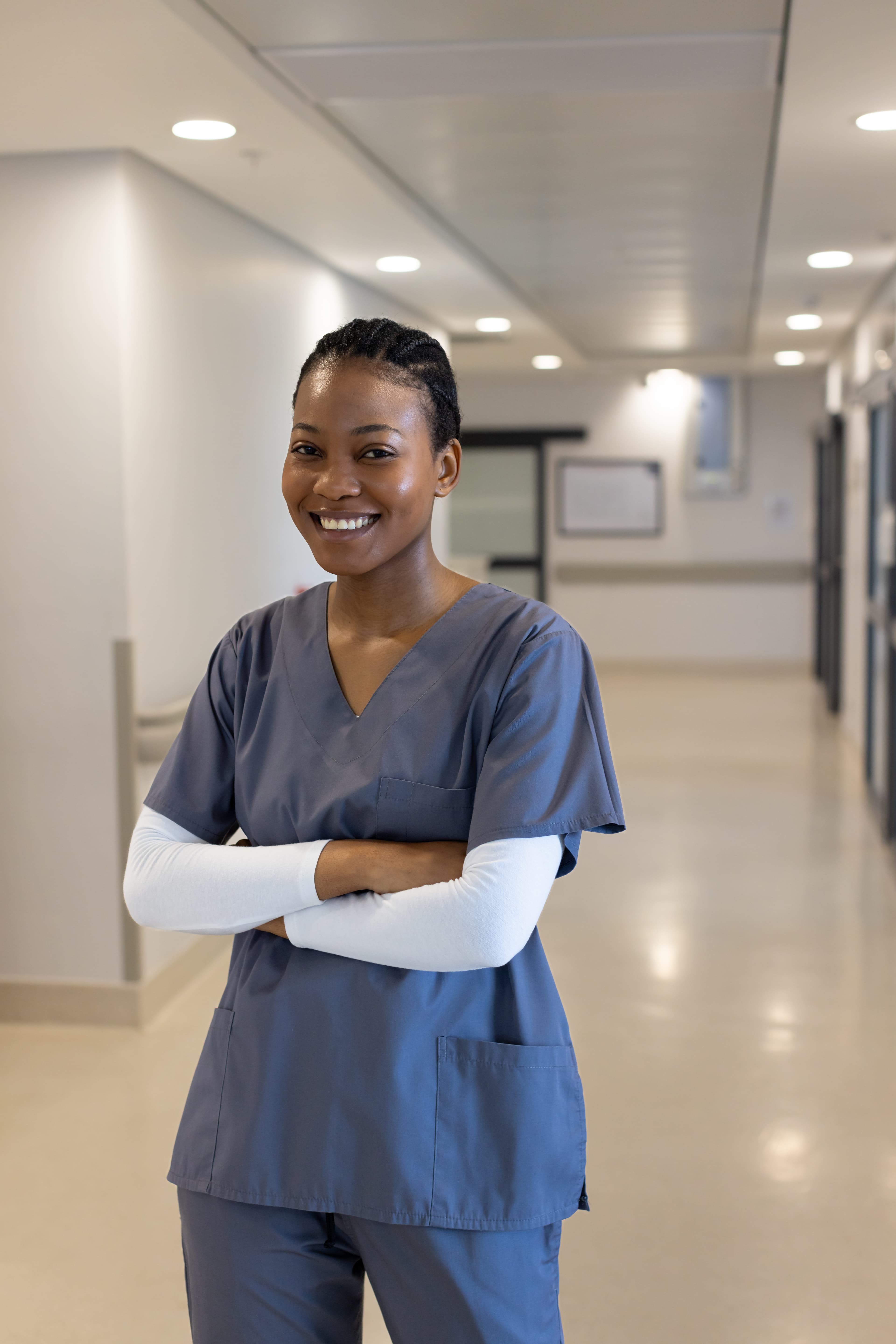 Strengthening Hospice and Palliative Education Smiling healthcare professional in scrubs standing in a clinical setting